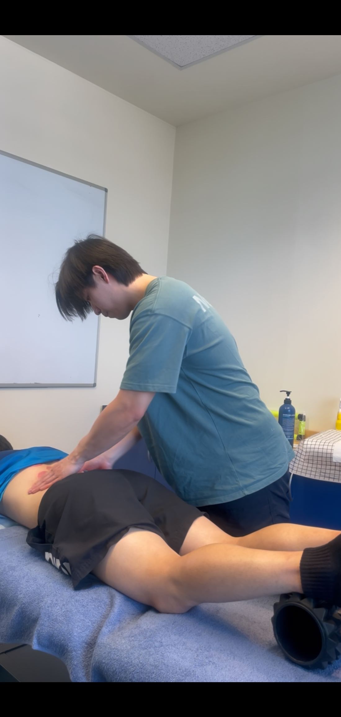 Fan performing hands-on treatment on a patient at FM Physiotherapy